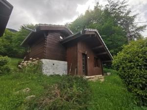 a small wooden building in a field of grass at Chalet Maria in Samoëns