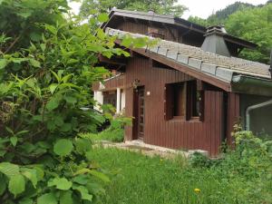 a small wooden house in the middle of a field at Chalet Maria in Samoëns