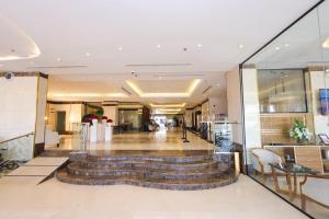 a lobby with a spiral staircase in a building at Diamond Vision Hotel in Jeddah