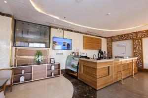 a kitchen with wooden cabinets and a sink at Diamond Vision Hotel in Jeddah