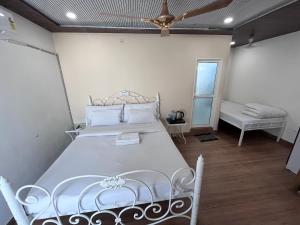 a bedroom with a bed and a ceiling fan at Joey's Hostel Jaipur in Jaipur +46 photos