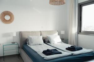 a bedroom with a bed with two pillows on it at Coral Bay Garden in Peyia +58 photos