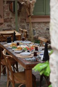 a wooden table with food on top of it at Chori Avlu Küçükköy in Ayvalık