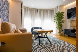 a living room with a couch and a table at Apartamentos Don Tomás in Jaén