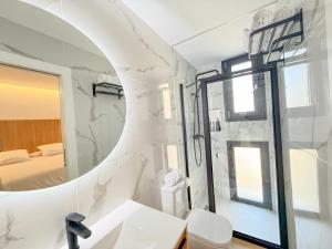 a bathroom with a shower and a toilet and a sink at Apartamentos Don Tomás in Jaén