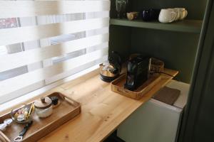 a kitchen with a wooden counter top with a coffee maker at Zielony Pokój in Ojców