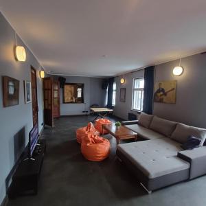 a living room with a couch and a table at Objekts Guesthouse - Creative Quarter Apartment in Riga