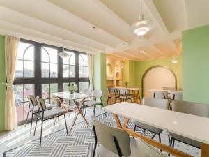 a room with tables and chairs and a large window at Little Charm Boutique Hotel in Hanoi