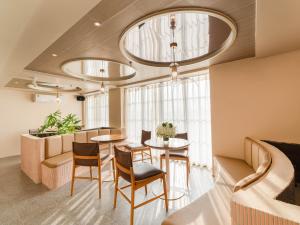 a dining room with a table and chairs in a room at Little Charm Boutique Hotel in Hanoi