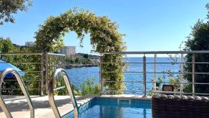 a swimming pool with a view of the water at Vila Nadja SEAFRONT in Bar