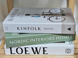 three books stacked on top of each other on a shelf at 행궁동-House2 in Suwon