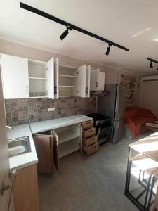 a kitchen with white cabinets and a refrigerator at Pierres Blanches Center in Mytilene +11 photos