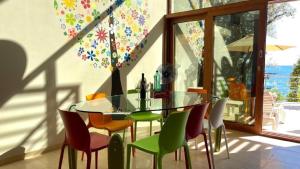 a dining room with a glass table and chairs at Vila Nadja SEAFRONT in Bar