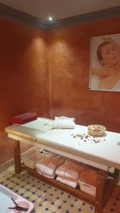 a table in a room with a shelf with towels at Kasbah Beldy Chic Marrakech, heated pool, spa in Marrakesh