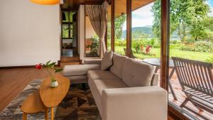 a living room with a couch and a table at The Buyan Resort Bedugul in Bedugul