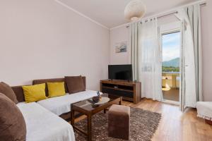 a living room with a couch and a tv at Maslina Krtoli in Tivat