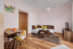 a living room with a bed and a table at Maslina Krtoli in Tivat +8 photos