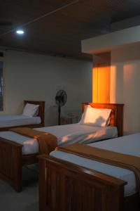 a room with three beds and a fan at Sai Dham Room Stay-01 in Kalyānpur
