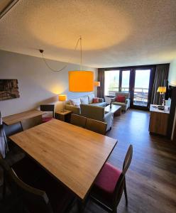 a living room with a table and a couch at Beatenberg Alpine Residence in Beatenberg