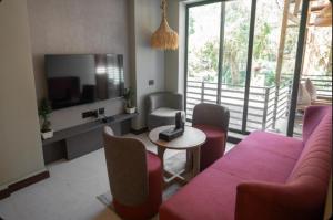 a living room with a couch and a table with chairs at Pixcel Holidays in Calangute