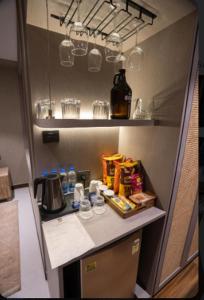 a kitchen counter with food and drinks on it at Pixcel Holidays in Calangute +20 photos