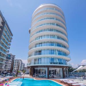 a tall building with a swimming pool in front of it at White Tower Mamaia Beach 602 in Mamaia