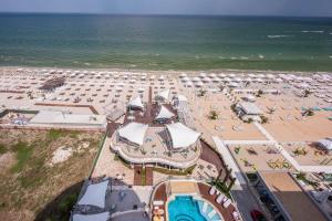 an aerial view of a beach with chairs and umbrellas at White Tower Mamaia Beach 602 in Mamaia
