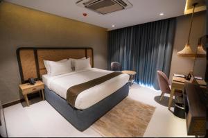 a bedroom with a bed and a desk and a computer at Pixcel Holidays in Calangute