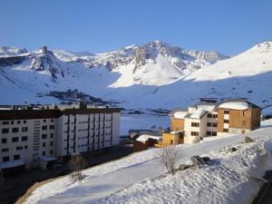 a city in the snow with mountains in the background at Le Bec Rouge in Tignes