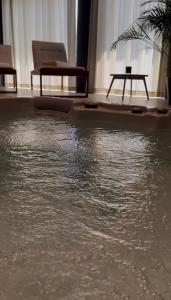a table sitting on top of water in a room at Hiša Marija Private Spa Villa in Zgornje Škofije