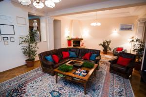 a living room with a couch and a coffee table at Interhouse Almaty in Almaty