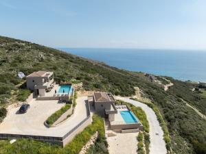 an aerial view of a house on a hill with the ocean at Lina's Luxury Villas in Skala
