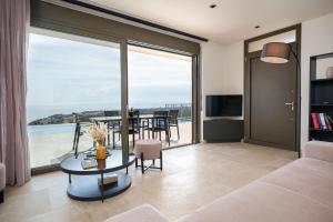 a living room with a view of the ocean at Lina's Luxury Villas in Skala