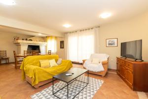 a living room with a couch and a tv at Villa Zubčić in Zadar