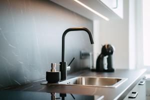 a kitchen counter with a sink and a sink at Sea view apartment Haapsalu in Haapsalu +13 photos