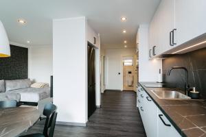 a kitchen with a sink and a couch at Sea view apartment Haapsalu in Haapsalu