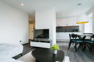 a living room with a couch and a table at Sea view apartment Haapsalu in Haapsalu