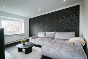 a living room with a couch and a table at Sea view apartment Haapsalu in Haapsalu