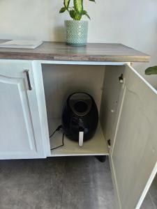 a cabinet with a pot sitting inside of it at Little Oasis in Hilton +2 photos