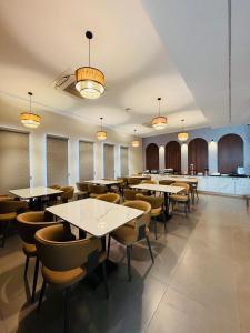 a dining room with tables and chairs and lights at 23 Urban Square in Hyderabad
