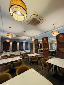 a dining room with tables and chairs and lights at 23 Urban Square in Hyderabad