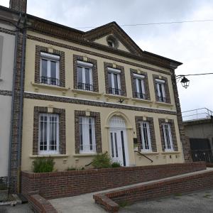 an old brick house with windows and a brick wall at gîte MAELYSE in La Neuve-Lyre