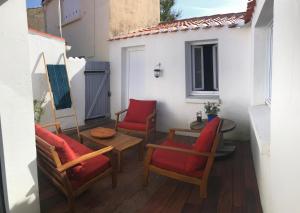 a patio with chairs and a table and a building at La trinquette in Saint-Gilles-Croix-de-Vie +5 photos