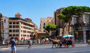 a horse drawn carriage on a city street at Hotel Forum in Rome