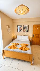 a bedroom with a bed with two towels on it at Mare Beachfront Rooms Himare in Himare +41 photos