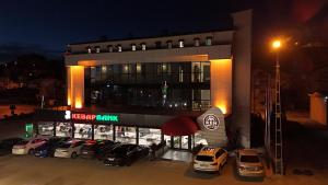 a car dealership with cars parked in front of it at Ren Business Hotel in Gerede