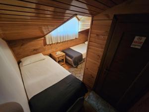 a small room with two beds and a window at HEVAS Suite in Ayder Yaylasi