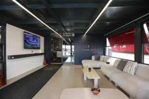 a living room with couches and a tv at Ren Business Hotel in Gerede