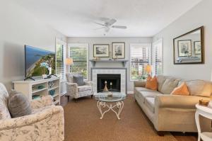 a living room with a couch and a fireplace at Harbour Oaks, Unit 419 in Saint Simons Island