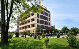 a building with a park in front of it at Hotel Europa Milano in Rosate